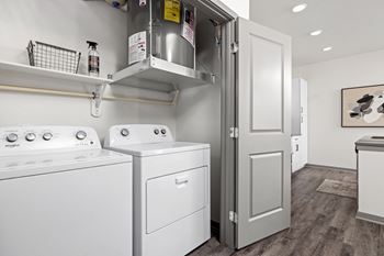 a white washer and dryer in a room with a refrigerator and a door at Upland Flats, Colorado, 80922